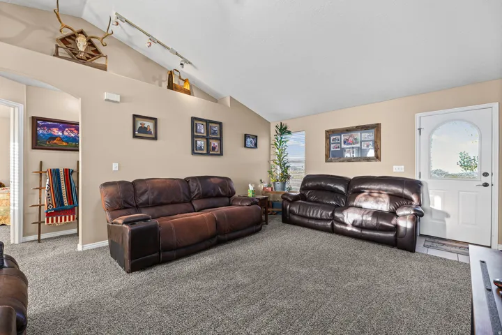 Vaulted ceilings, archway entry, and a front entry door with an arched window