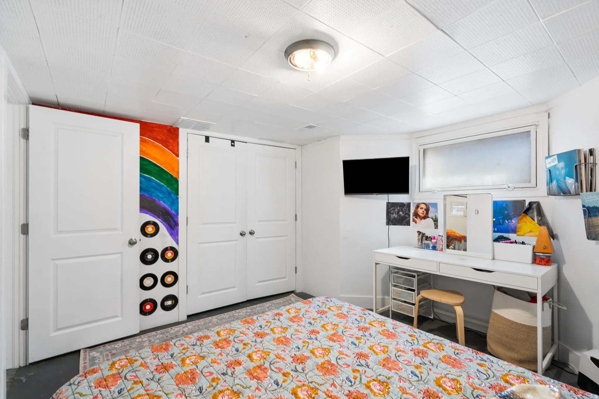 White paneled interior doors, wall-mounted television, and a recessed window