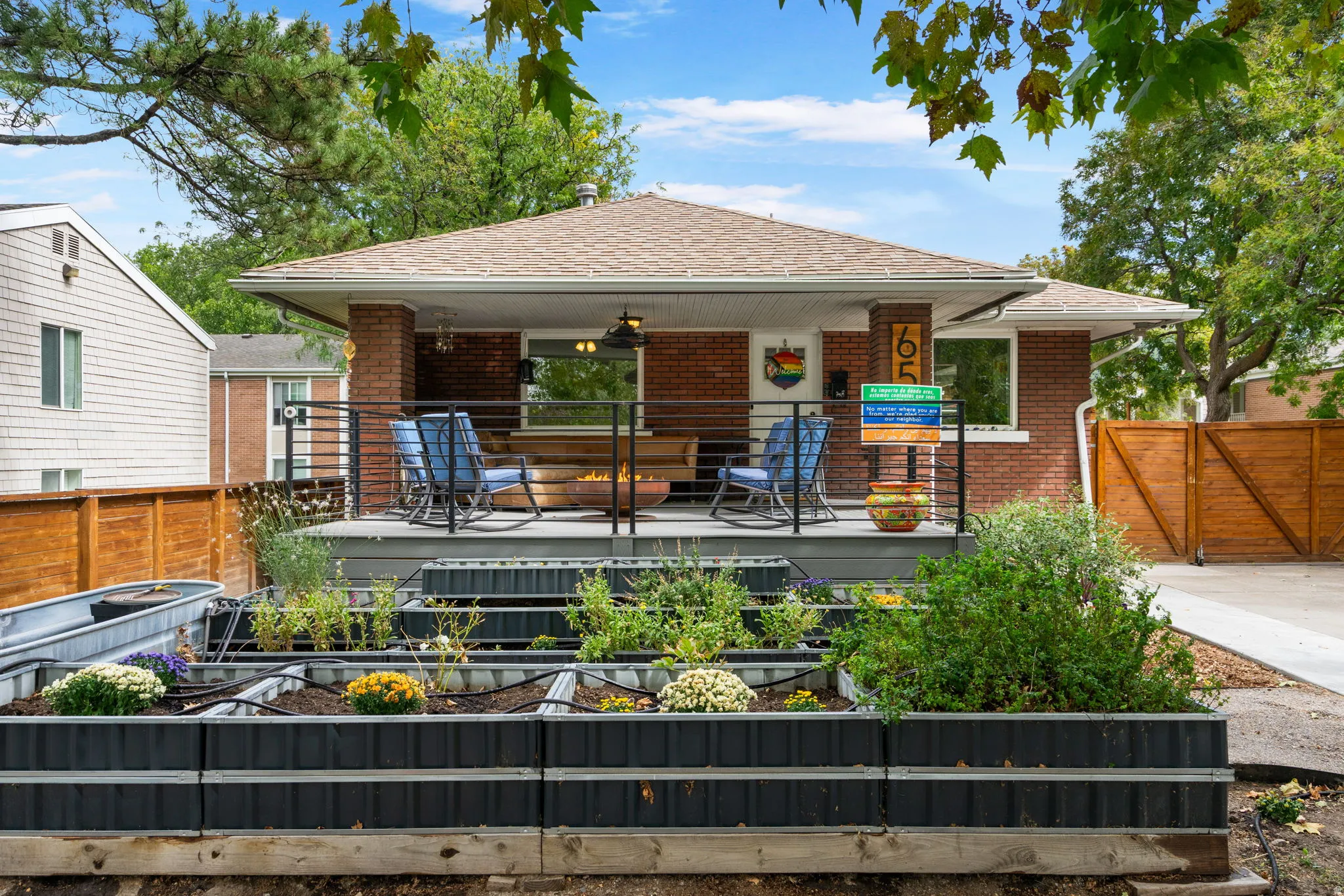 Brick exterior with covered porch, composite decking, and metal railings