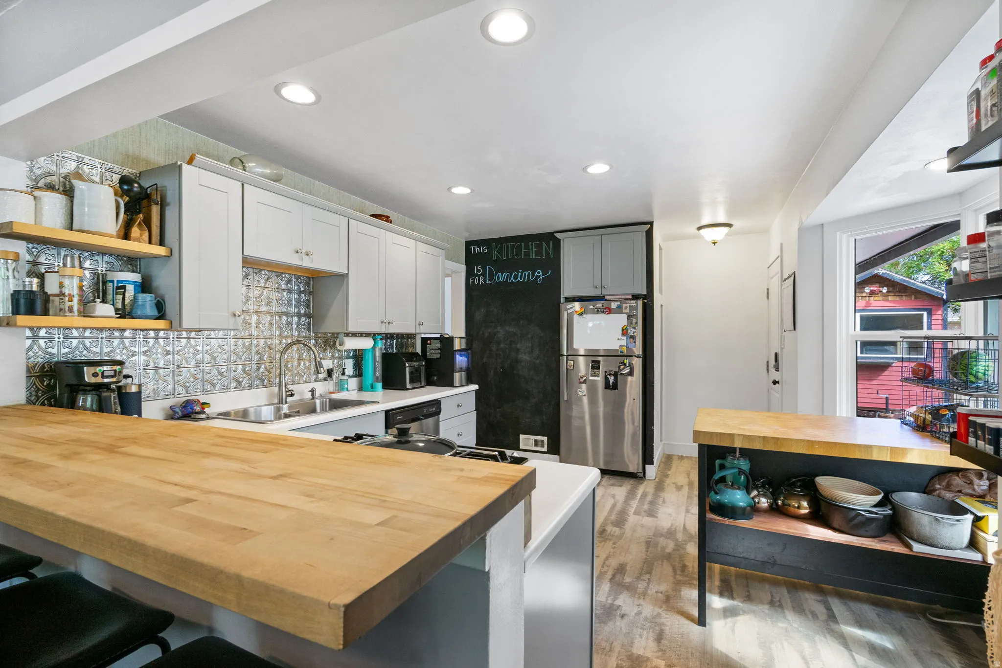 Kitchen featuring light wood-finish flooring, recessed lighting, light gray cabinetry, a tile backsplash, and a butcher block countertop