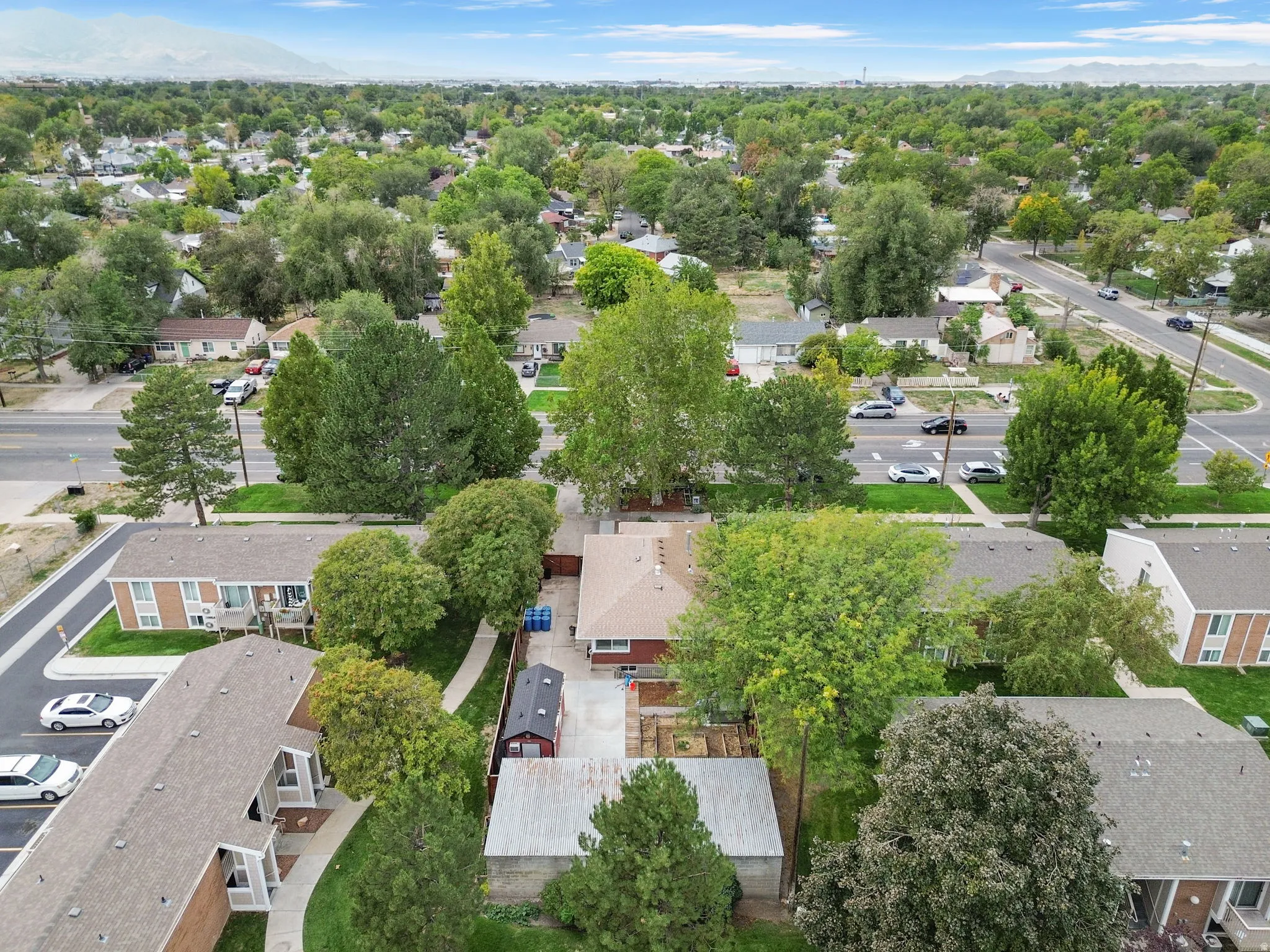 Residential property with mature trees, established neighborhood setting, and mountain backdrop