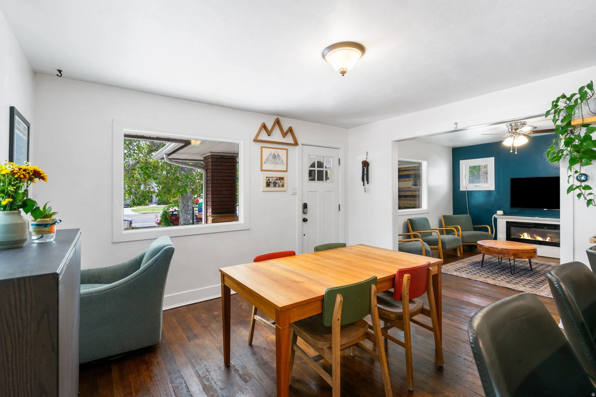 Hardwood flooring, recessed lighting, and a built-in fireplace with a white mantel