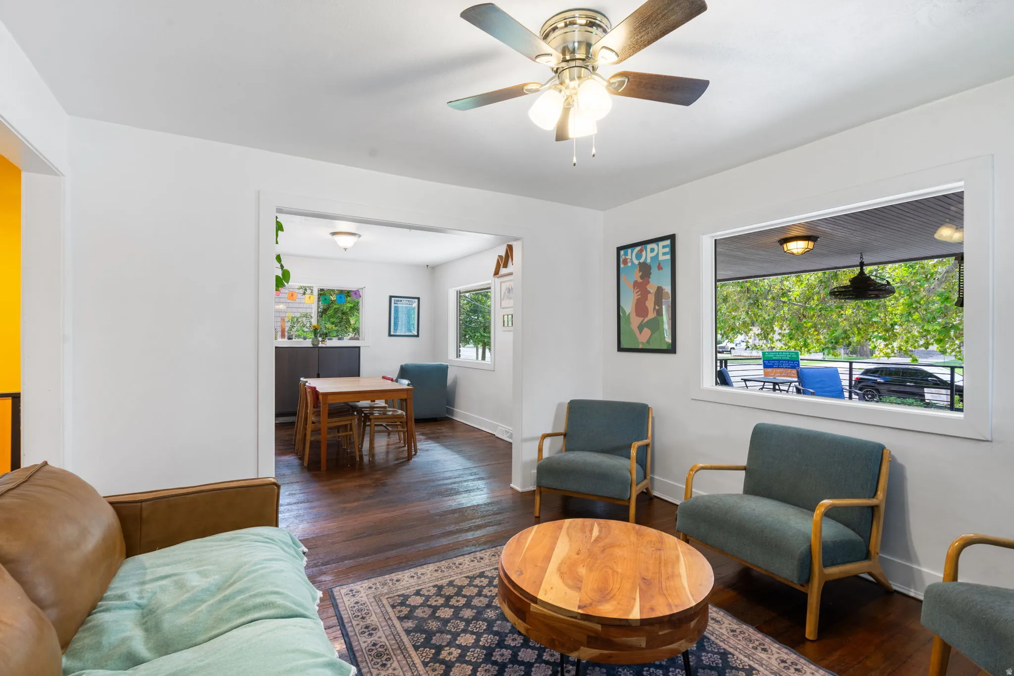 Hardwood flooring, recessed lighting, ceiling fan, and white trim throughout