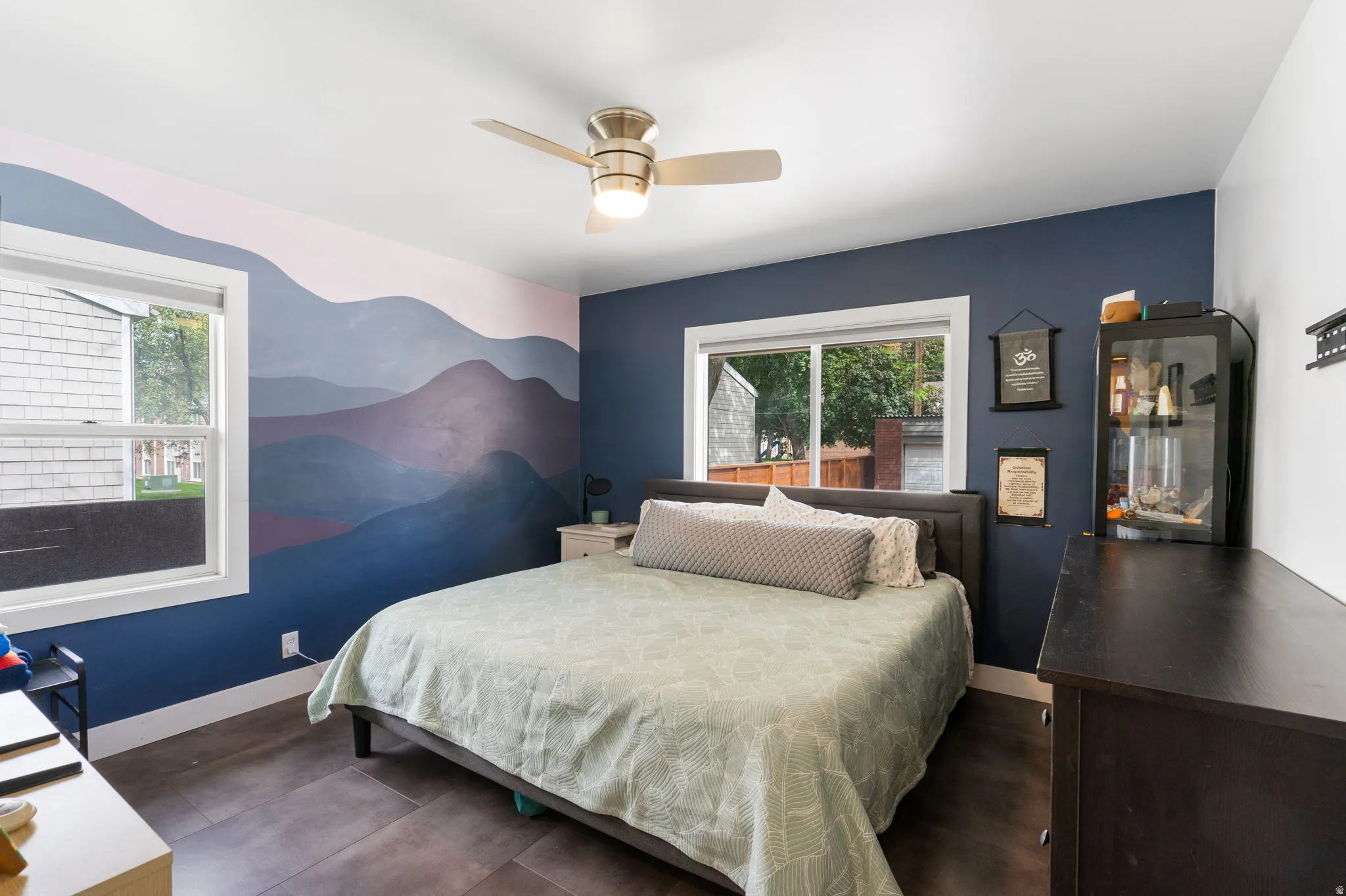 Recessed lighting, wood-finish flooring, two large windows, and a ceiling fan with integrated lighting