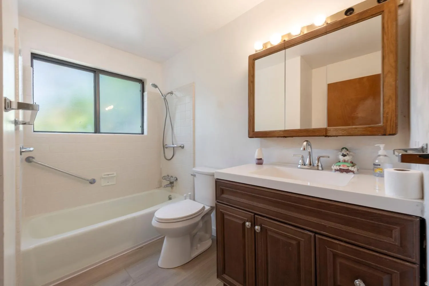 Bathroom featuring a vanity with dark wood-finish cabinetry, a white countertop, and an integrated sink