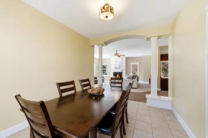 Tile flooring, recessed lighting, arched entryway, decorative columns, wood-finish flooring