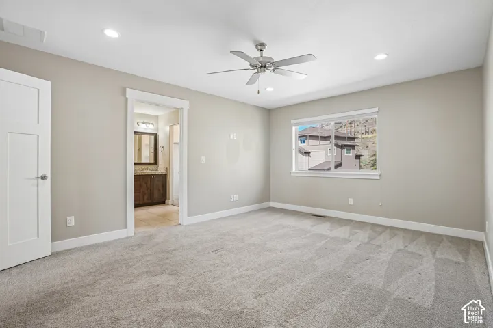 Spacious room with plush carpet flooring and recessed lighting