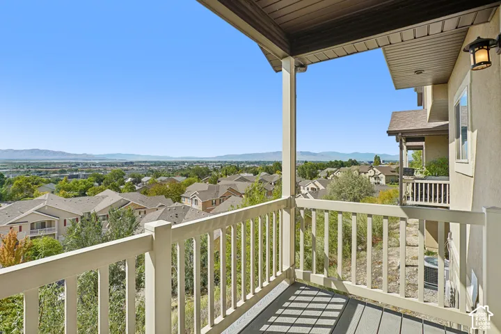 Covered balcony with composite decking and light-colored railing