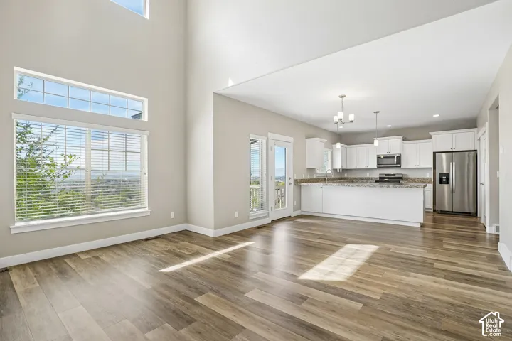 Expansive living area with wood-finish flooring and high ceilings