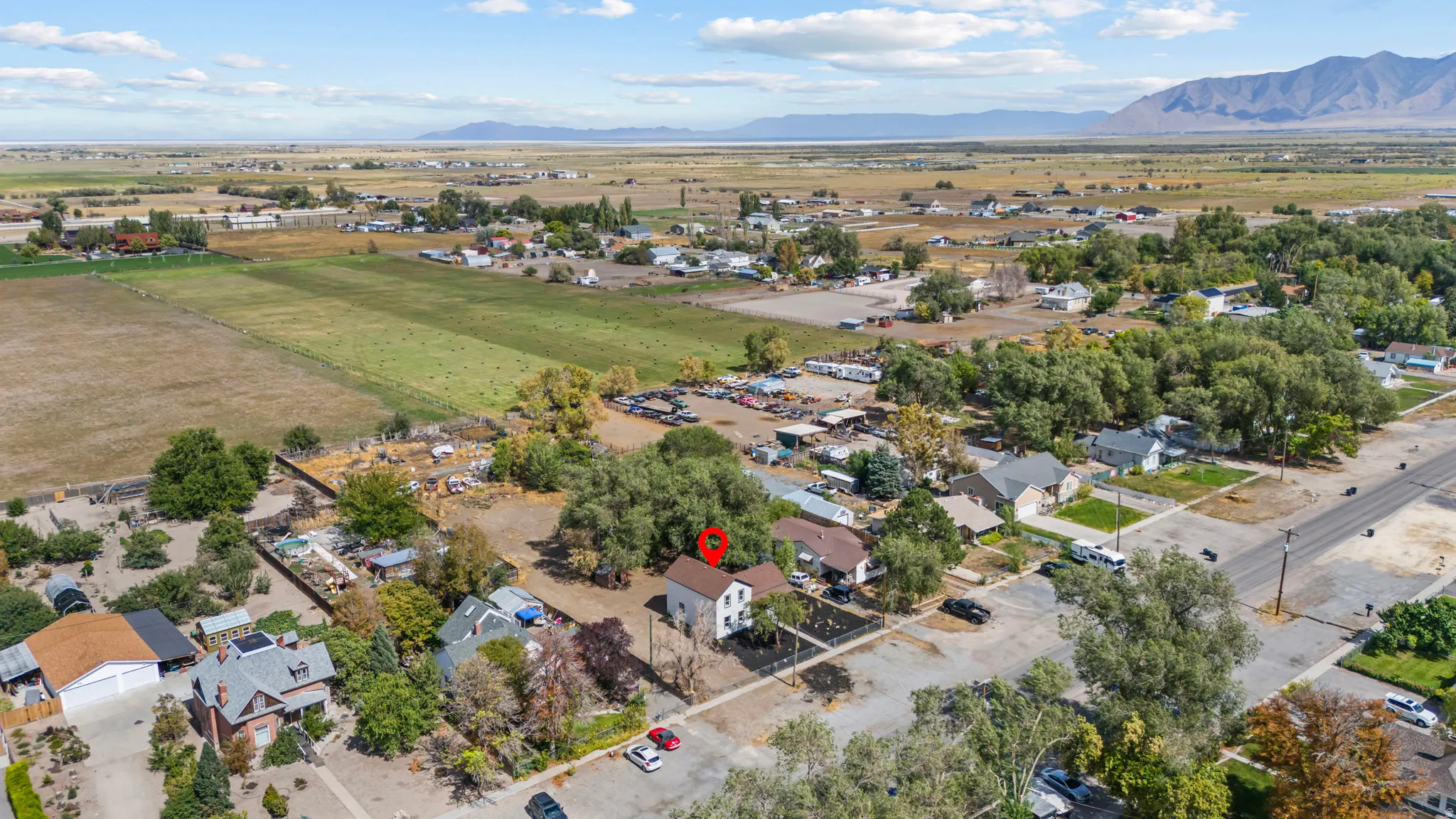 Rural property with expansive surrounding fields and distant mountain ranges