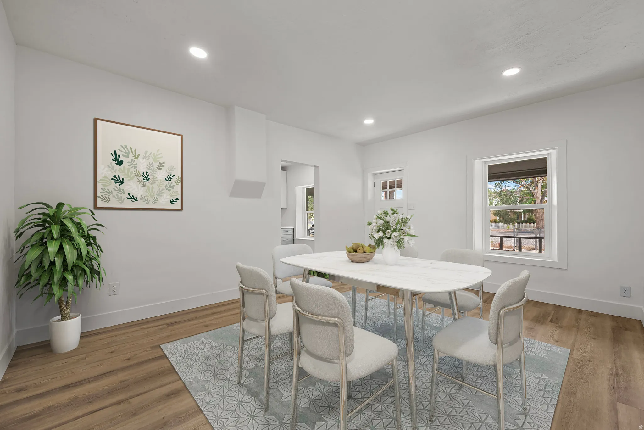 Recessed lighting, wood-finish flooring, white trim, and multiple windows