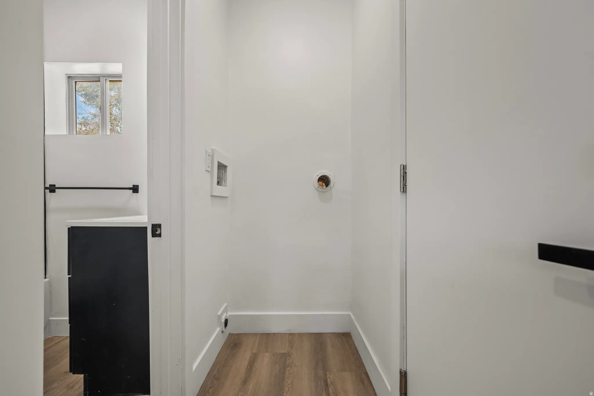 Wood-finish flooring with white walls and trim