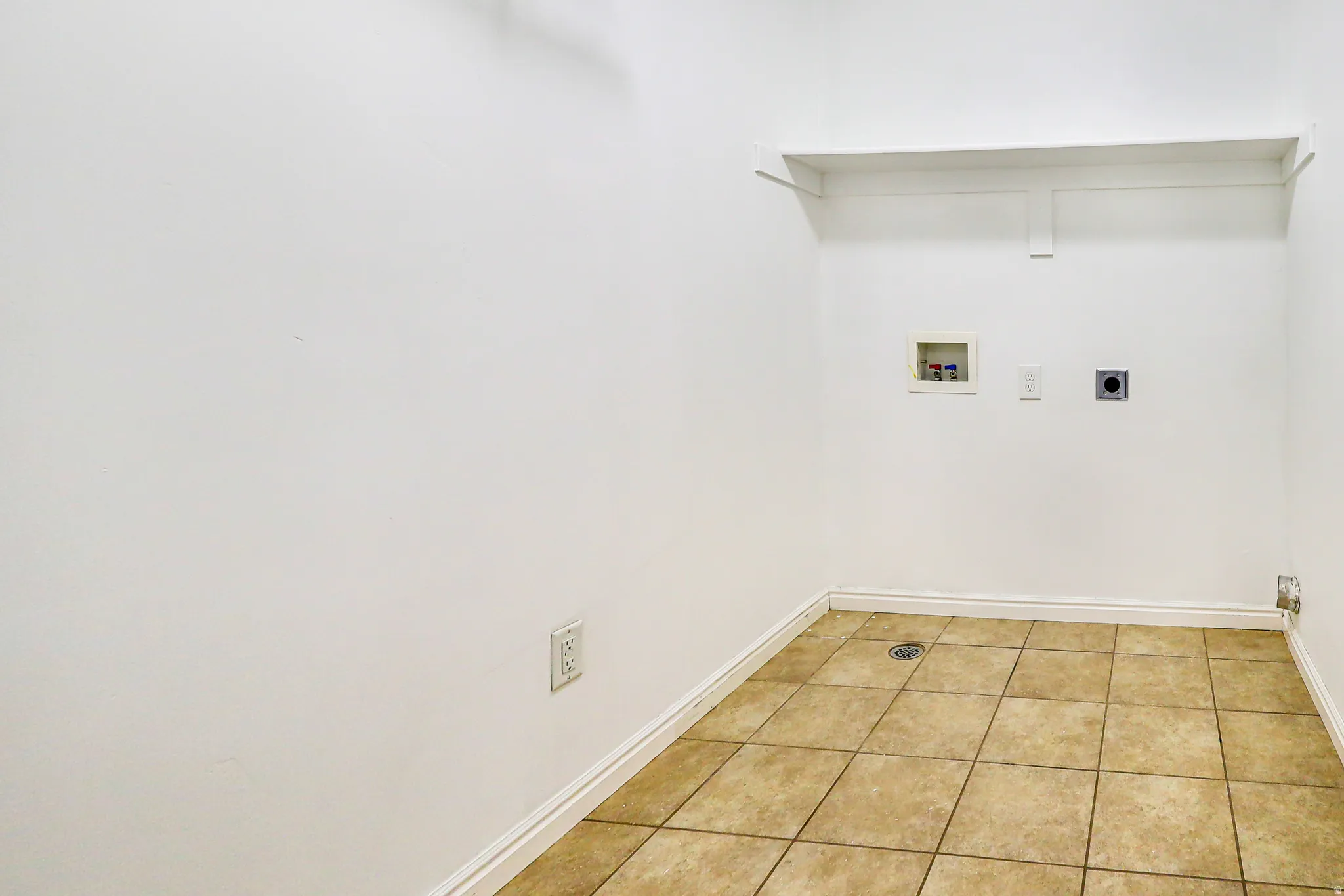 Tile flooring, white walls, and built-in shelving