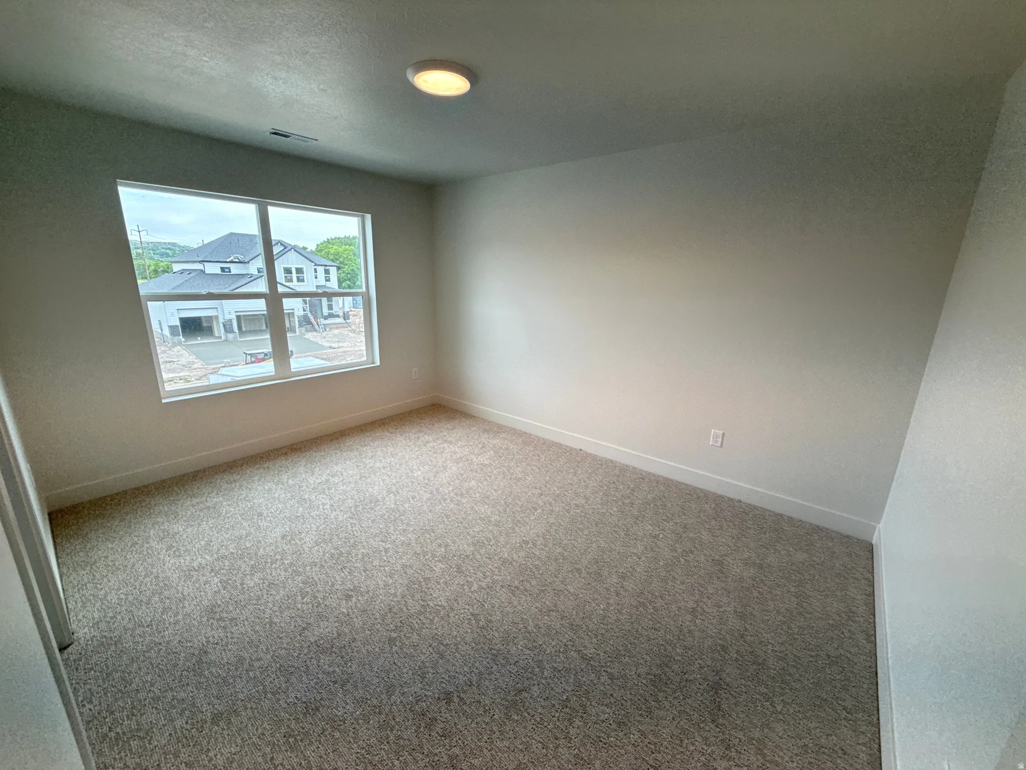 Neutral wall finishes and light gray carpet