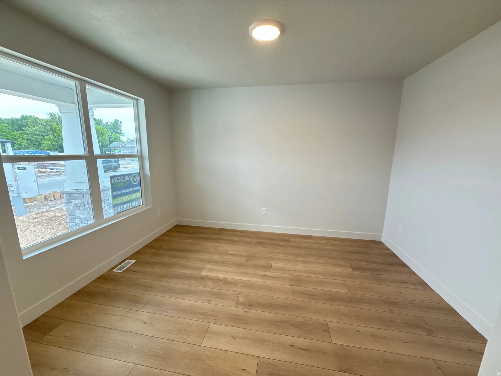 Wood-finish flooring with crisp white walls and trim