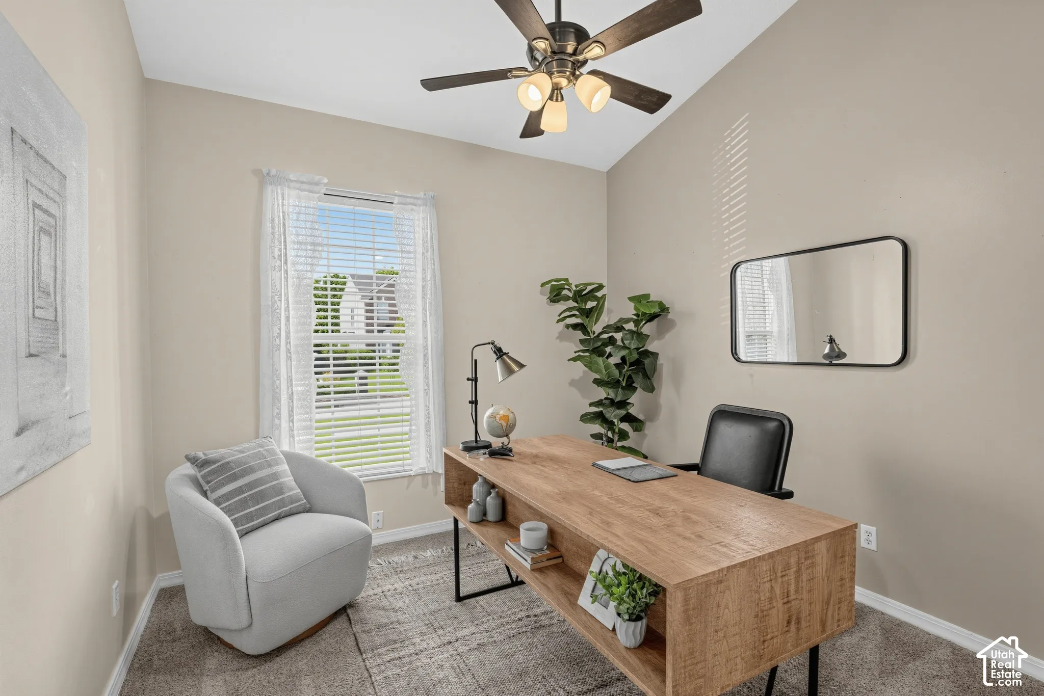 Vaulted ceiling featuring a ceiling fan with integrated lighting, a large window with blinds, and neutral-toned wall paint