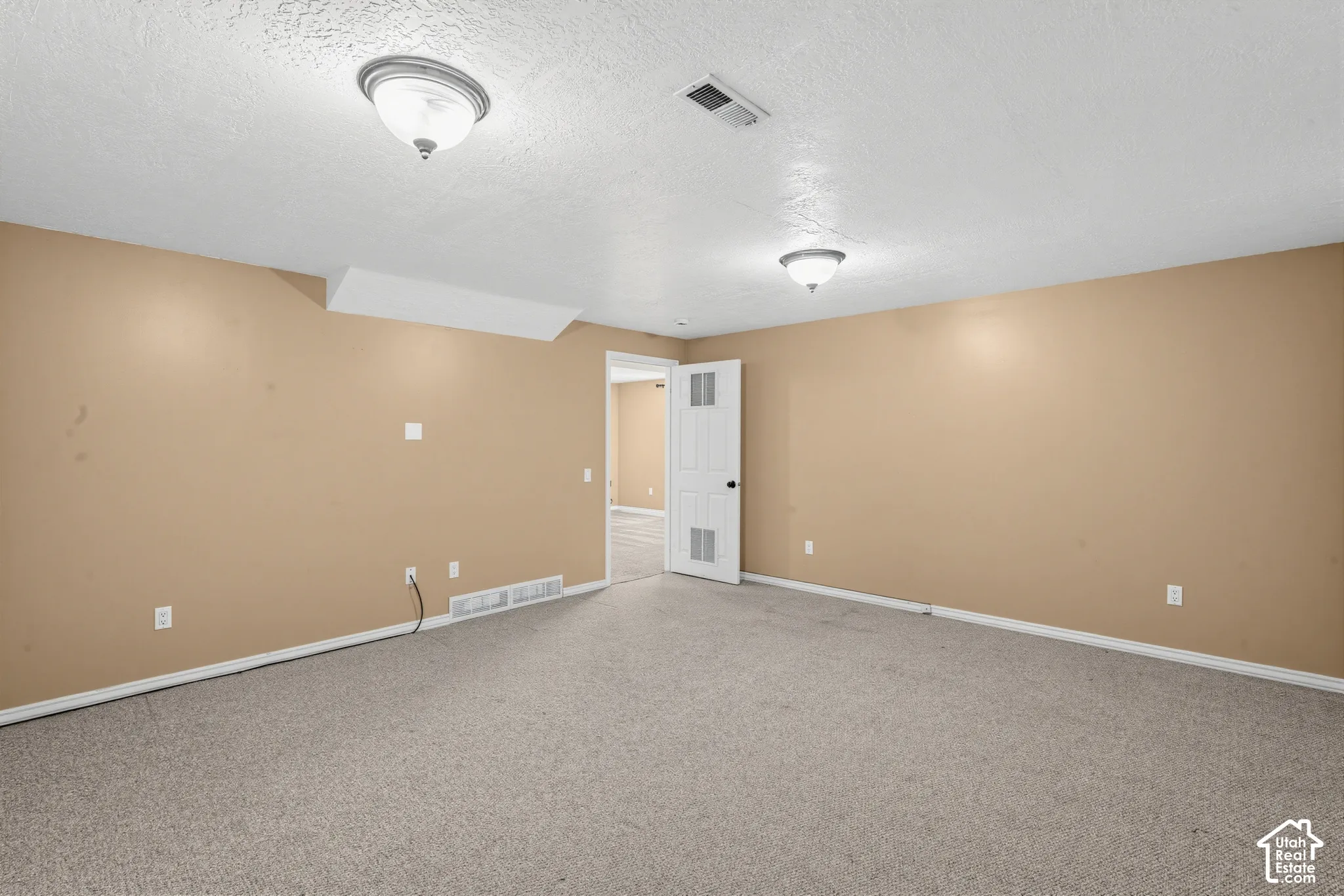 Neutral-toned walls complement the textured ceiling