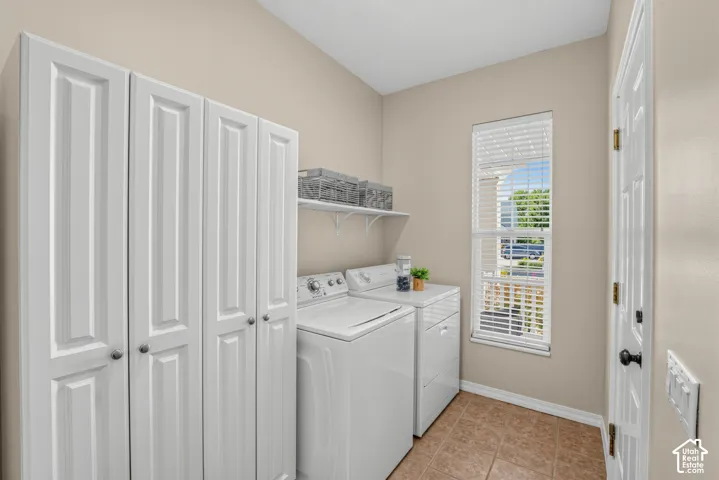 Laundry area featuring white built-in cabinetry
