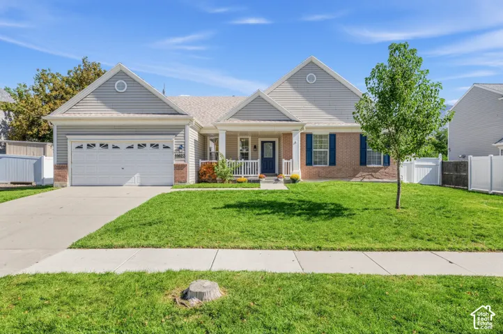 Brick and siding exterior with a covered front porch and a two-car garage