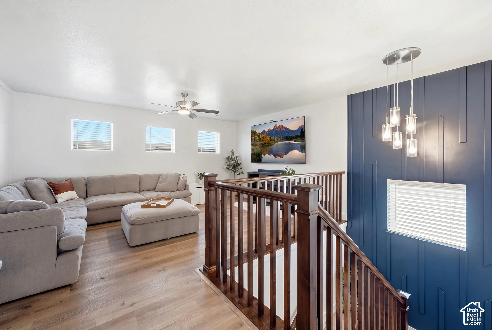 Wood-finish flooring throughout, with a rich wood staircase and railings