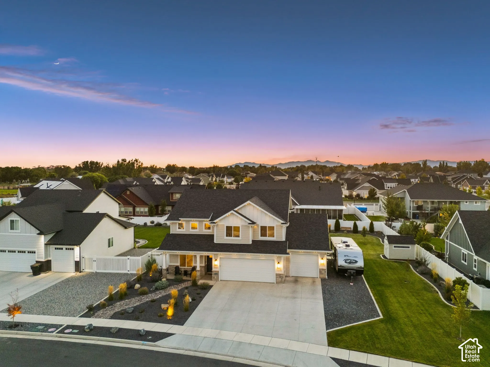 Two-story residence with a light-colored exterior and dark roof