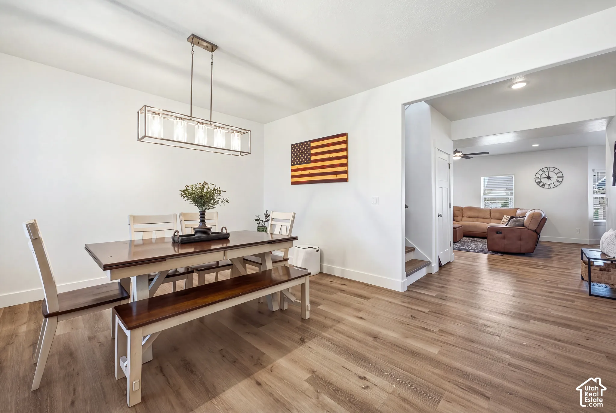 Wood-finish flooring throughout, white walls, and a recessed ceiling light fixture