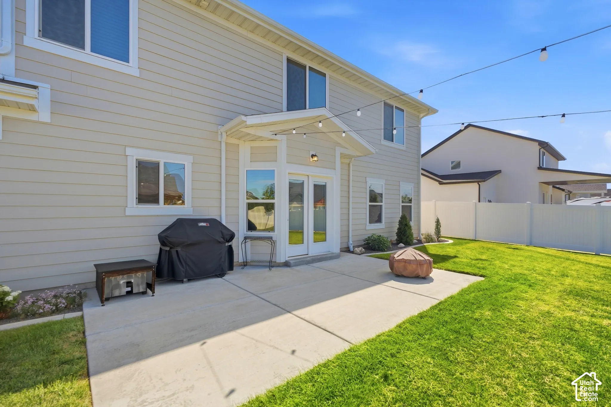 Rear exterior with light-colored horizontal siding and white trim