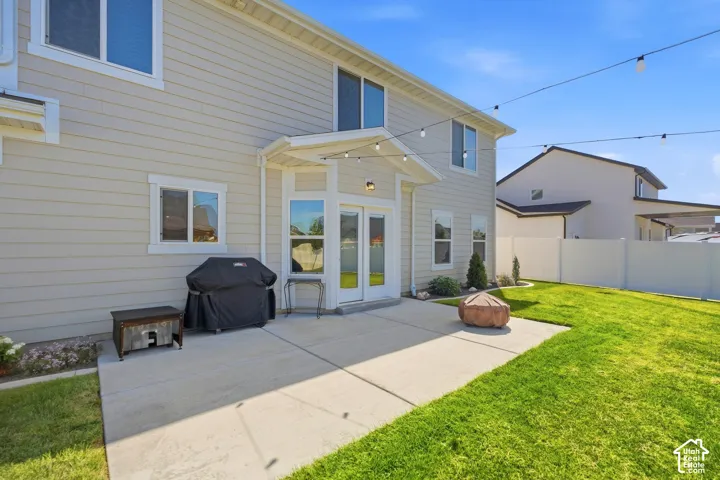 Rear exterior with light-colored horizontal siding and white trim