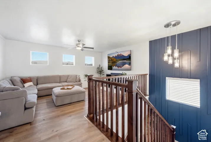 Wood-finish flooring throughout, with a rich wood staircase and railings