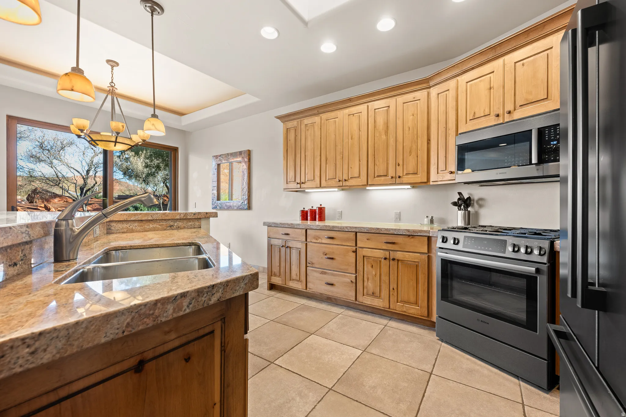 Kitchen featuring wood cabinetry, stainless steel appliances, and a double basin sink