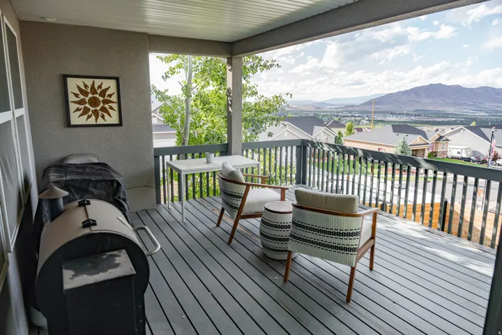 Covered outdoor deck with grey composite decking and dark grey railings