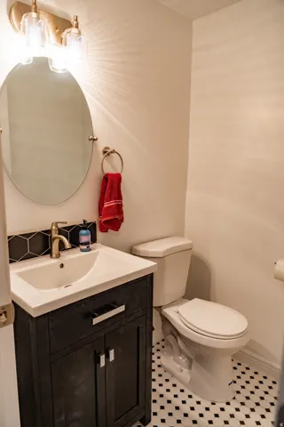 White tile flooring with black diamond accents