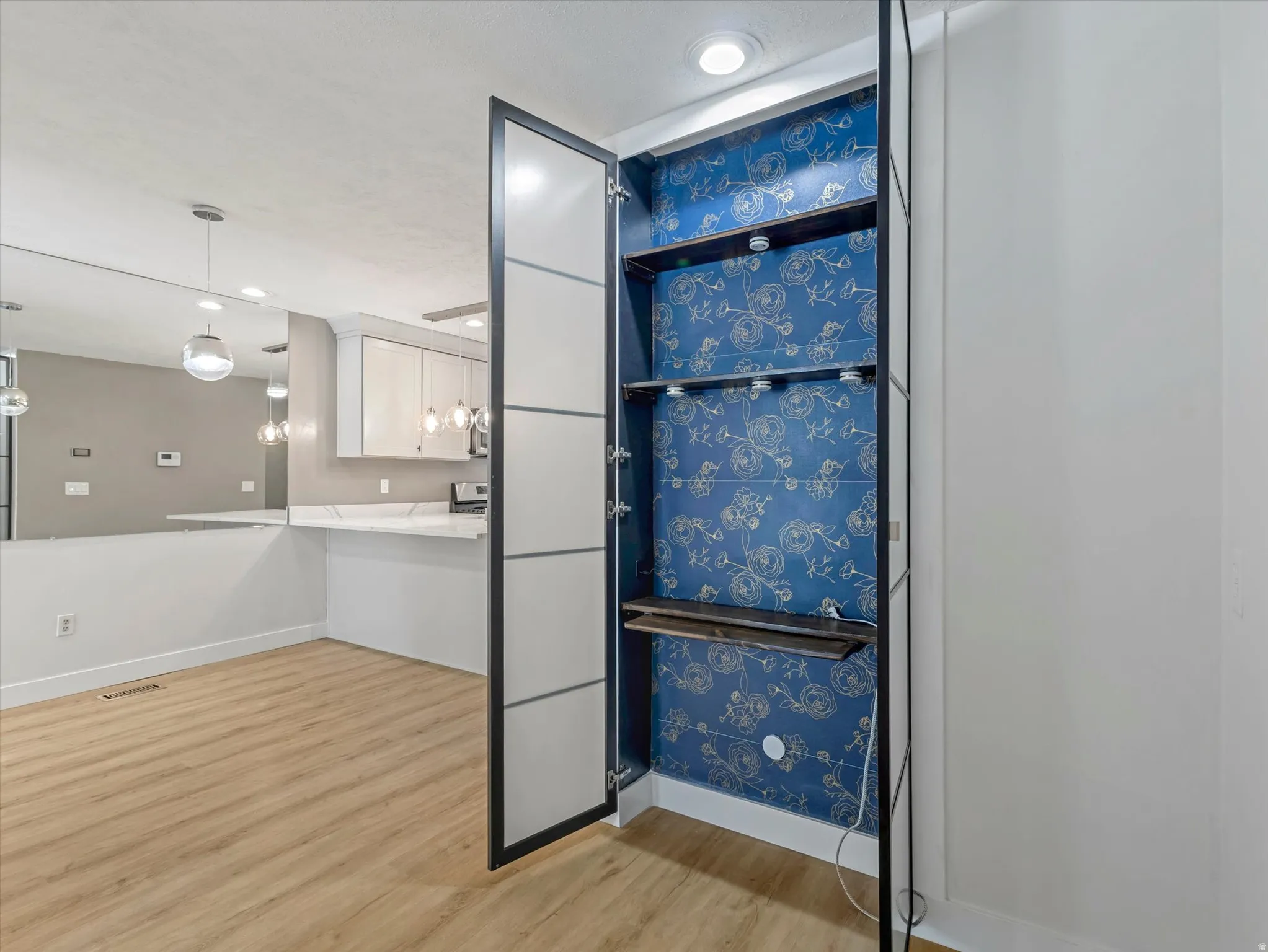 Built-in shelving with decorative wallpaper accent