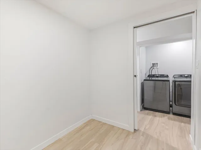 View from basement Office into Laundry area with light LVP flooring