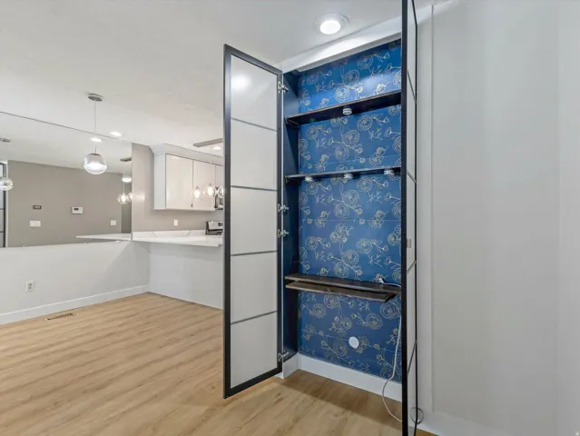 Built-in shelving with decorative wallpaper accent