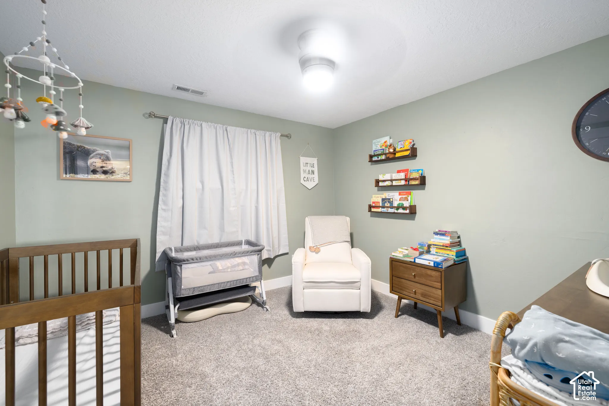 Recessed ceiling light, light gray wall paint, gray carpet flooring, white window treatments, and white trim