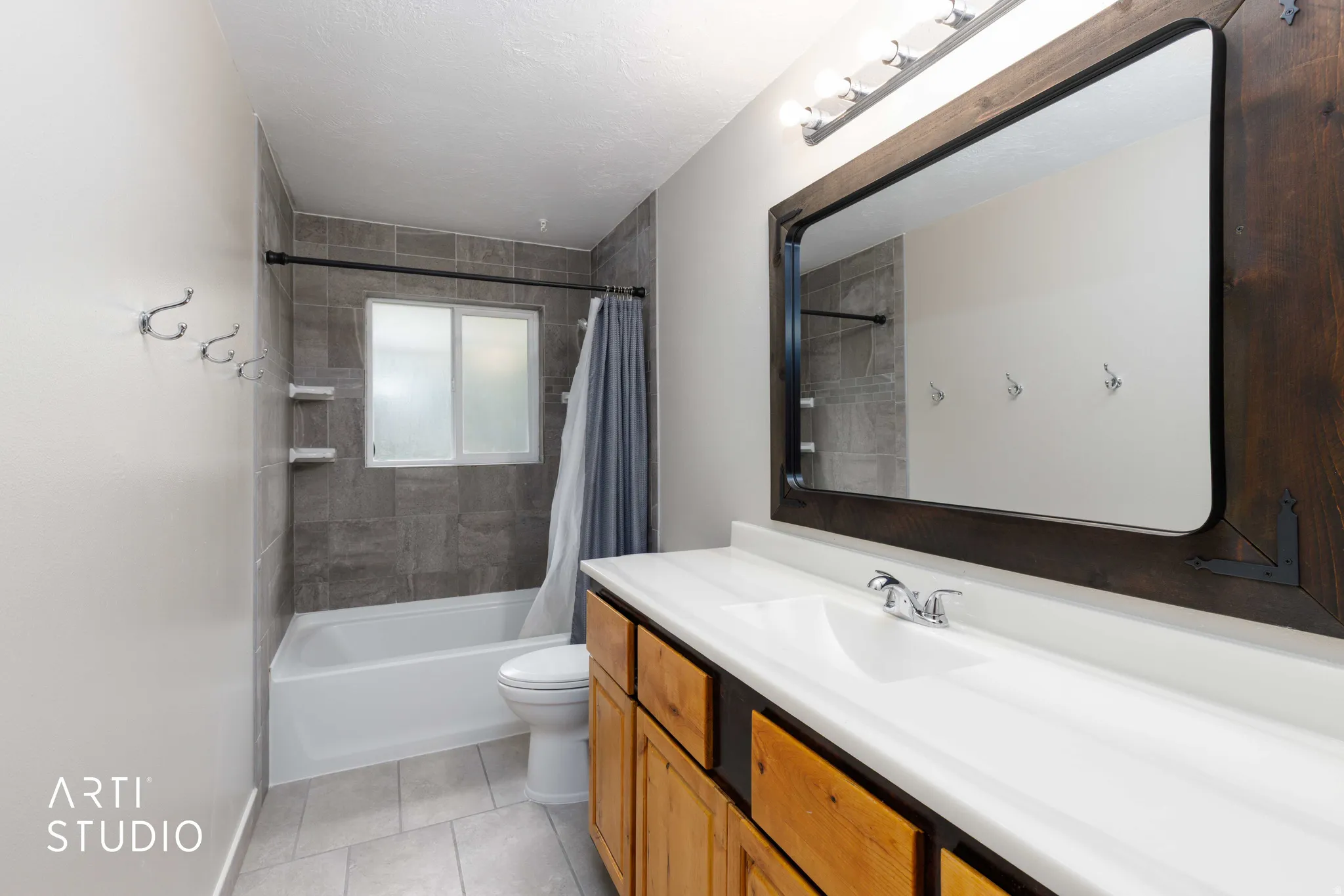 Full Bathroom featuring a single vanity with a wood-finish cabinet, white countertop, and rectangular undermount sink