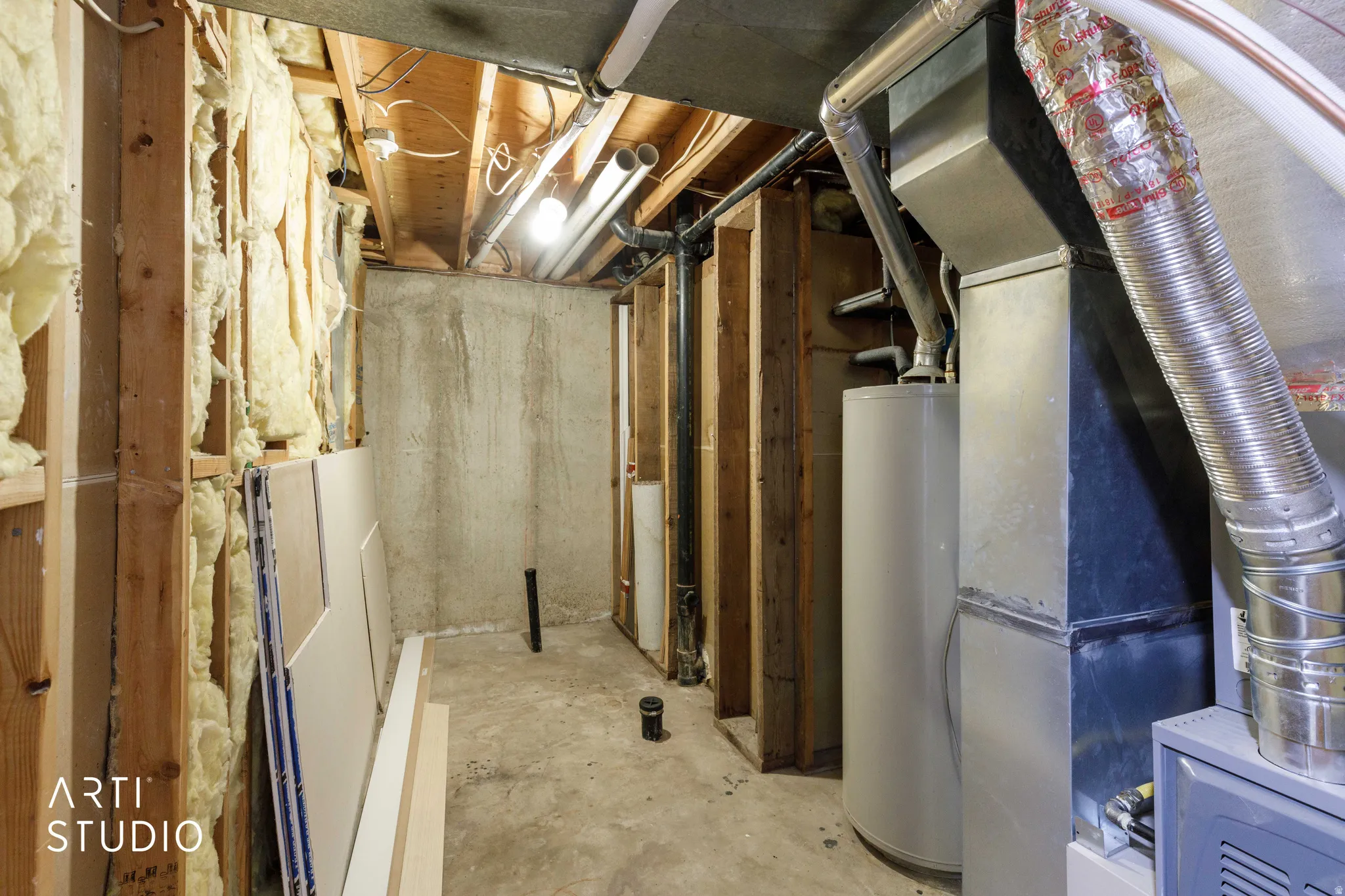 Basement area featuring exposed wood framing showing plumbing for additional bathroom.