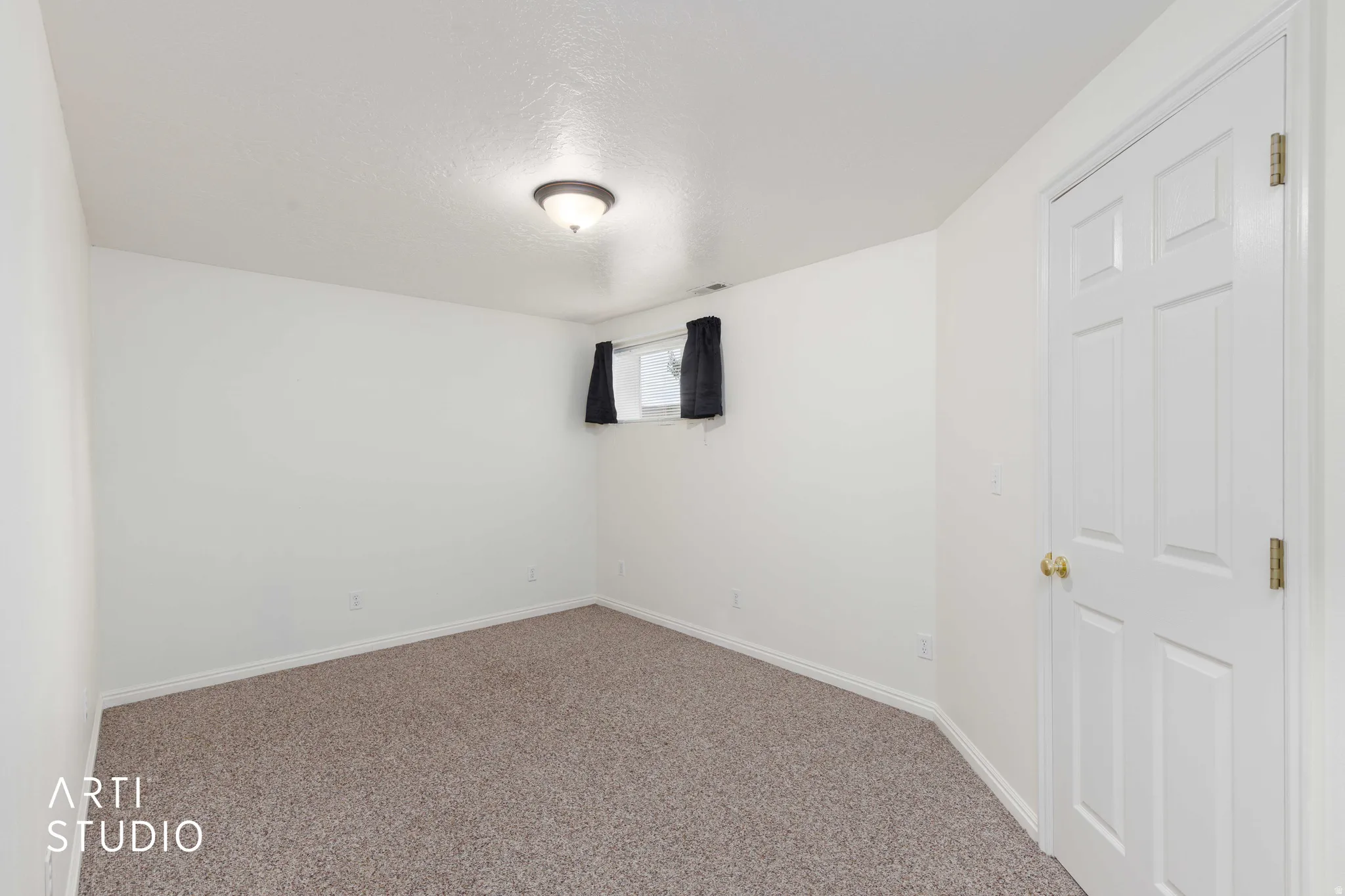 Neutral-toned wall-to-wall carpeting complements the light-toned walls