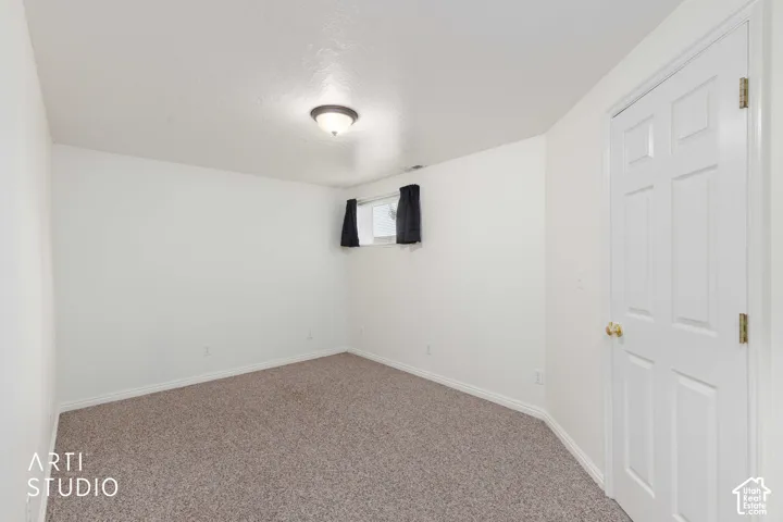 Neutral-toned wall-to-wall carpeting complements the light-toned walls