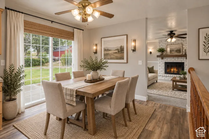 Dining area, digitally decorated with integrated lighting, wall sconces, and a painted brick fireplace