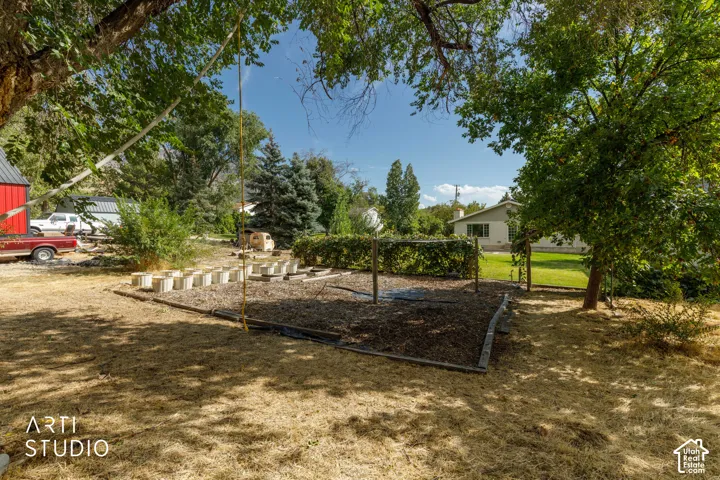 Expansive outdoor space featuring mature trees, a designated garden area.