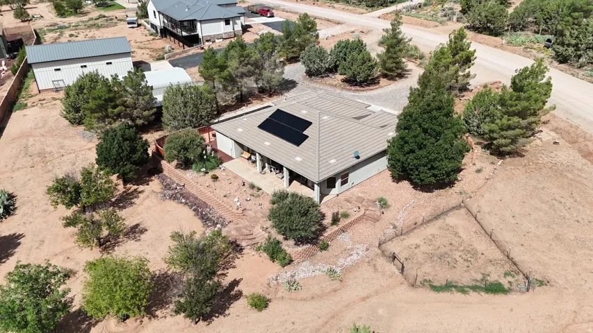 Ranch-style residence featuring a tile roof and solar panels