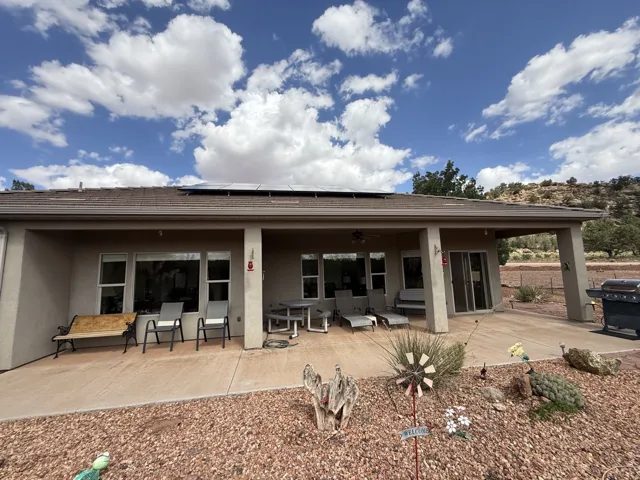 Expansive covered patio with recessed lighting, multiple windows, and a sliding glass door