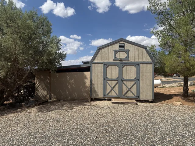 Barn-style shed with double doors and window-style accent