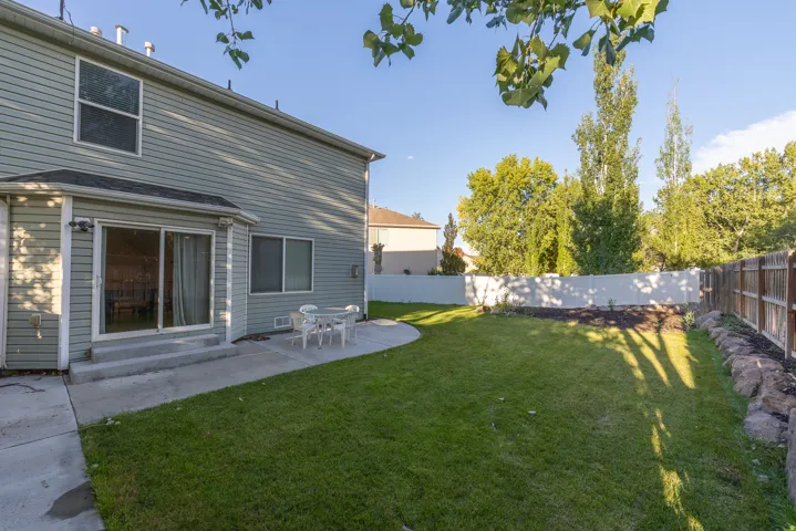 Beautiful backyard with curved concrete patio & private fencing