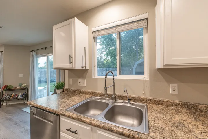 Kitchen featuring beautiful views, a double basin stainless steel sink, & pull-down faucet