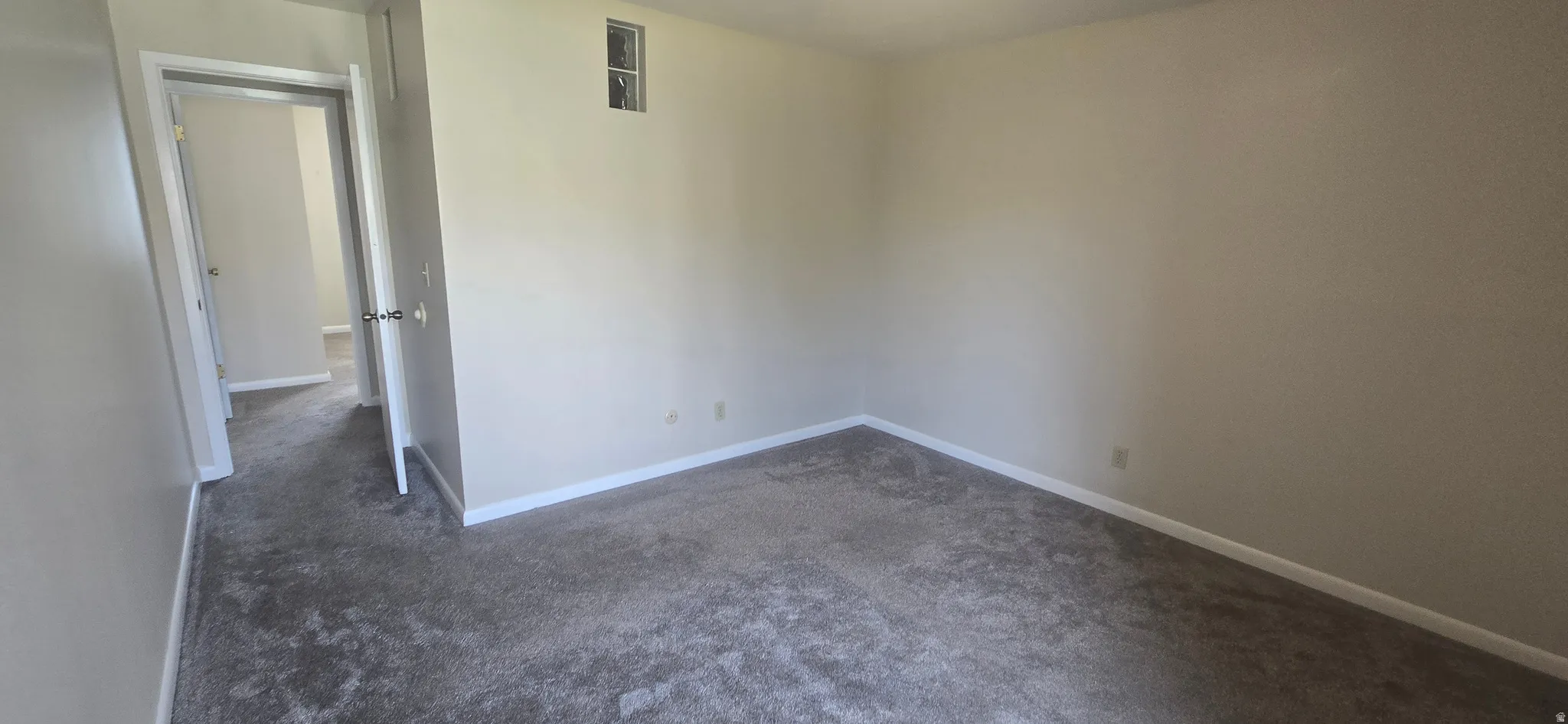 Neutral-toned walls complement gray carpeting, creating a versatile interior