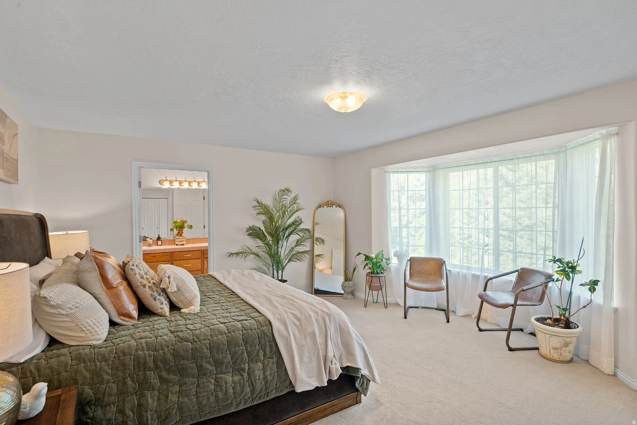 Bay window with multiple panels, recessed overhead lighting, and neutral carpet flooring