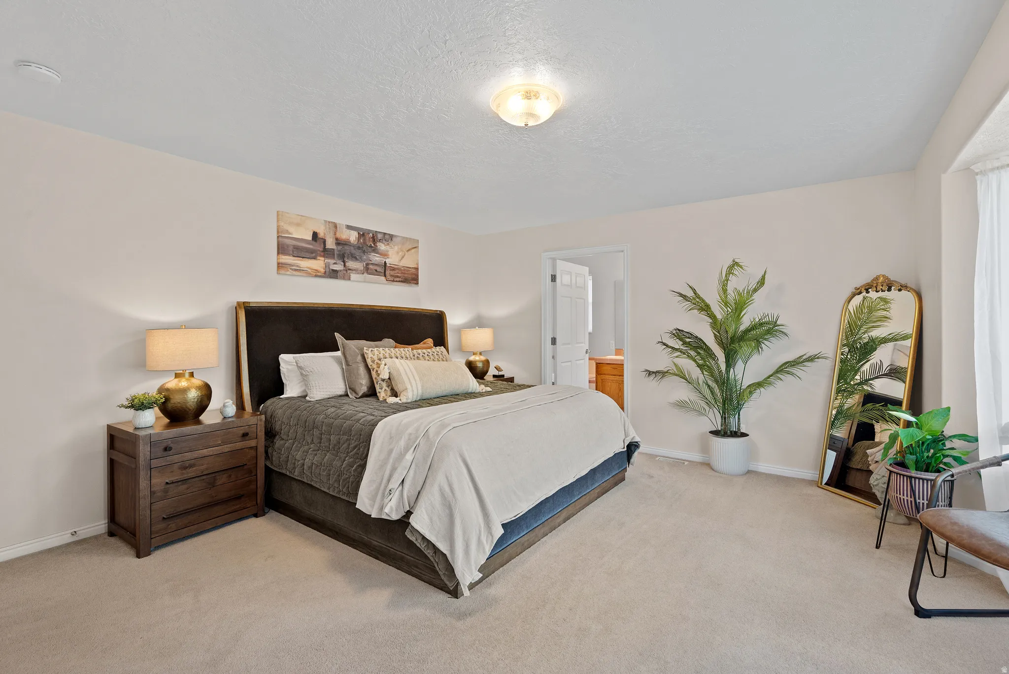 Plush carpet flooring, recessed window, and overhead flush-mount lighting